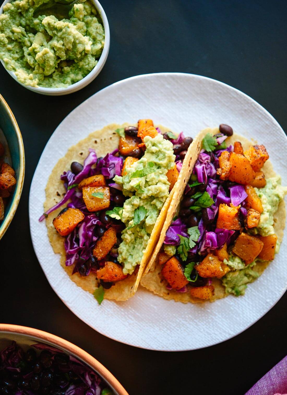 These roasted butternut squash tacos with slaw are bursting with flavor and so good for you, too. cookieandkate.com