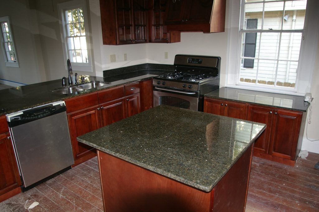 A stainless steel exhaust hood over a commercial kitchen cooking line