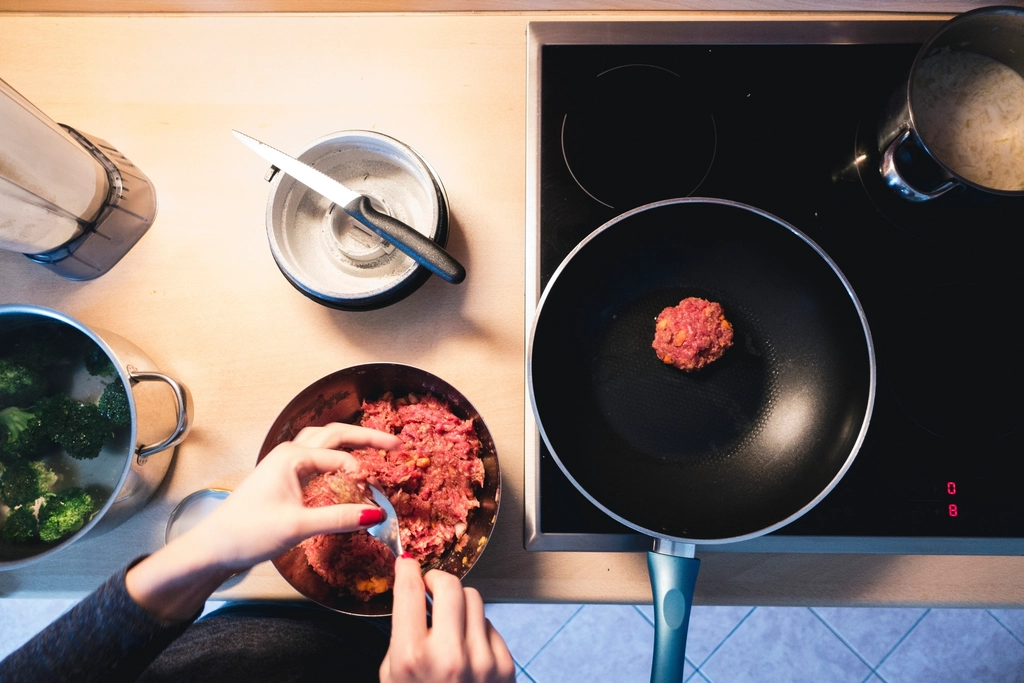 Frying ground beef burger