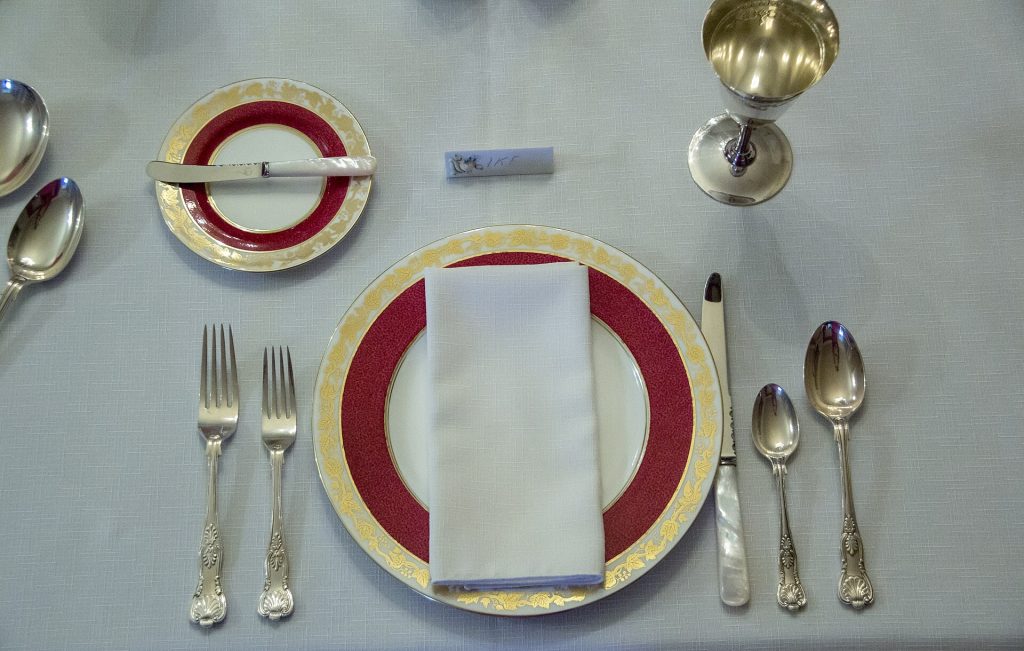 A long dining table set for a holiday dinner party