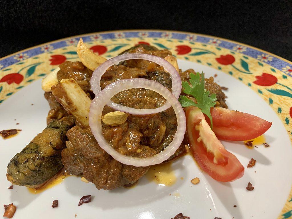 Shared platters of roasted food served family-style on a table