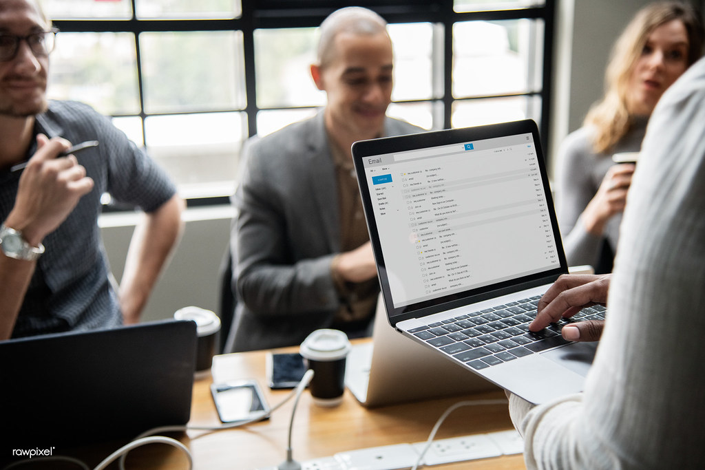 A laptop on a desk showing an email inbox