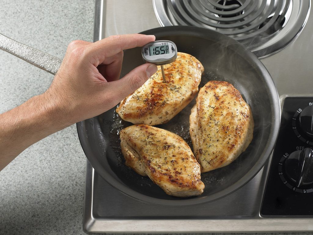 A digital probe thermometer checking the temperature of food