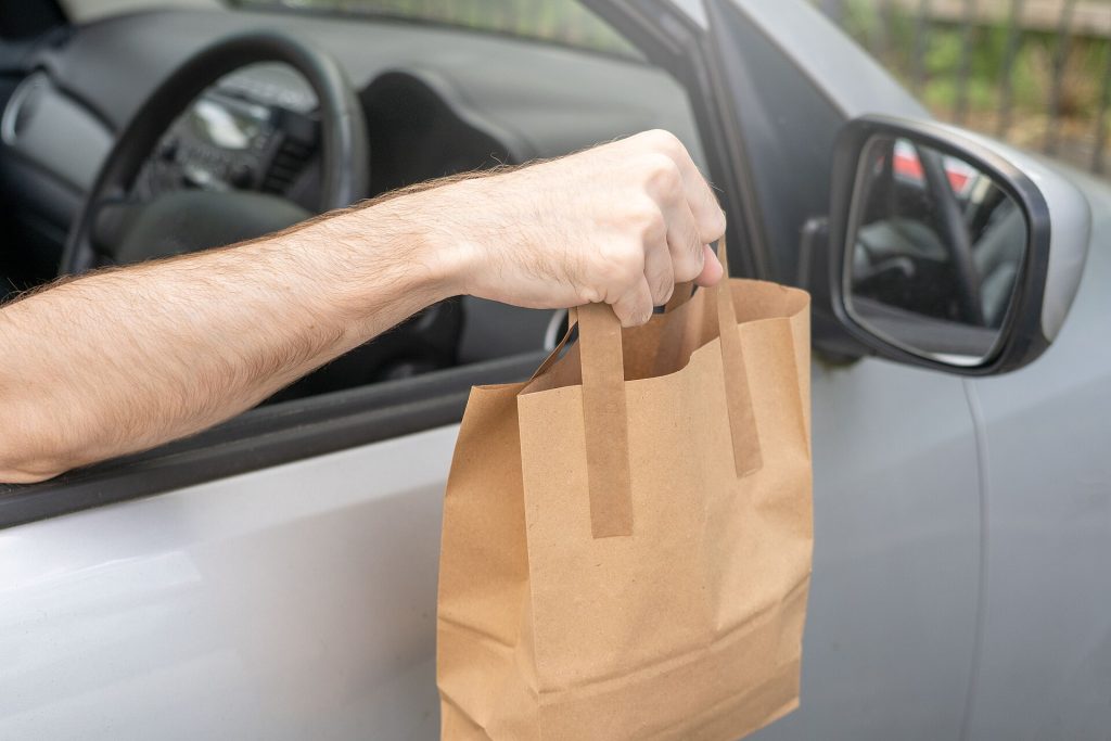 A folded paper takeout bag on a restaurant counter