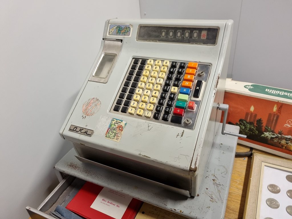 A calculator next to a printed sales receipt