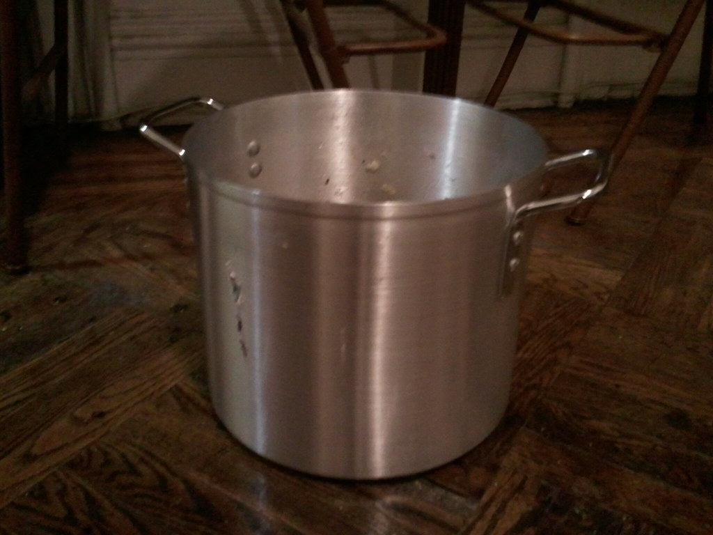 Stockpot of soup cooling in an ice water bath in a commercial kitchen