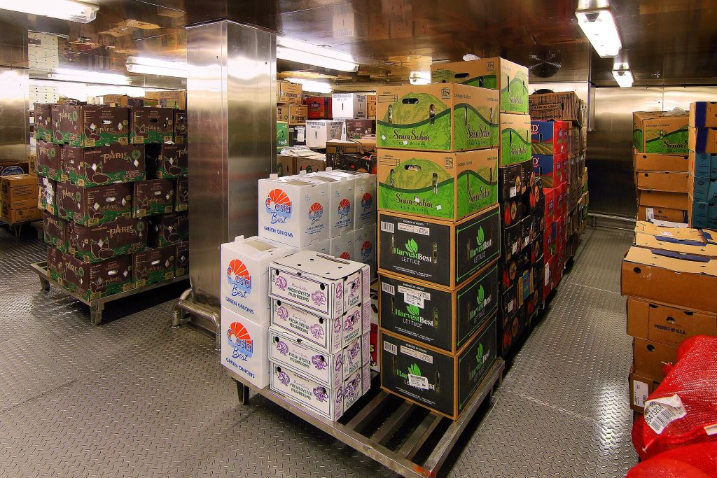 Stocked shelves inside a restaurant walk-in cooler